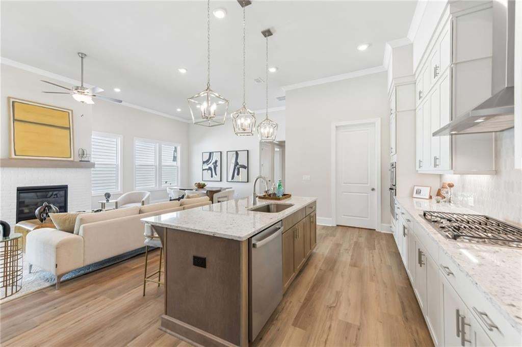 Ample kitchen space in cabinets, under cabinet lighting is a standard in our kitchens.  Quartz countertops, high ceilings on main floor!! Photo not of actual home but a previously built TPG home.