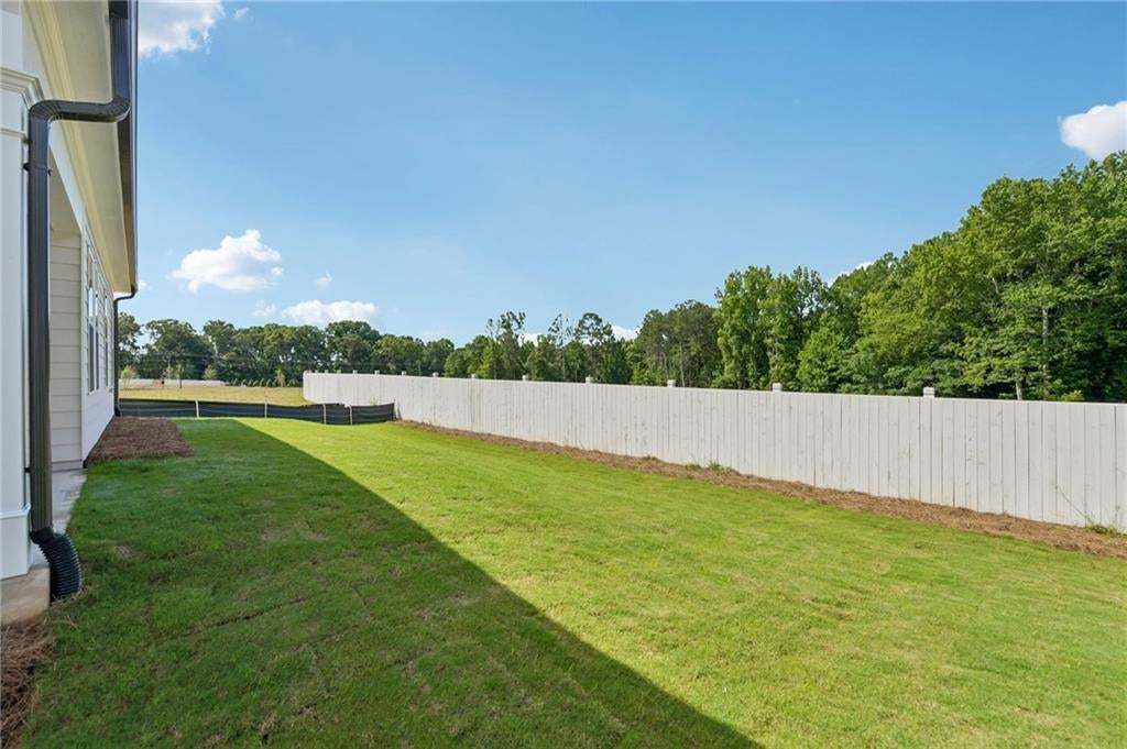 This lot is going to have a nice sized yard and privacy on the side where the patio will be. Photo not of actual home but a previously built TPG home.