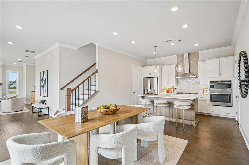 Open-concept kitchen and dining area. Perfect for a crowd or table set for one. Kitchen vent hood is vented directly to exterior.