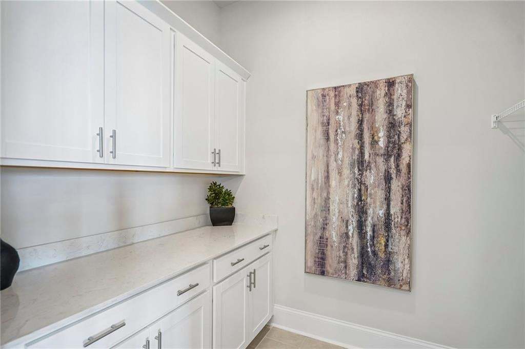 Extra cabinets in the laundry room- perfect to store appliances and costco goodies and makes a great folding station.