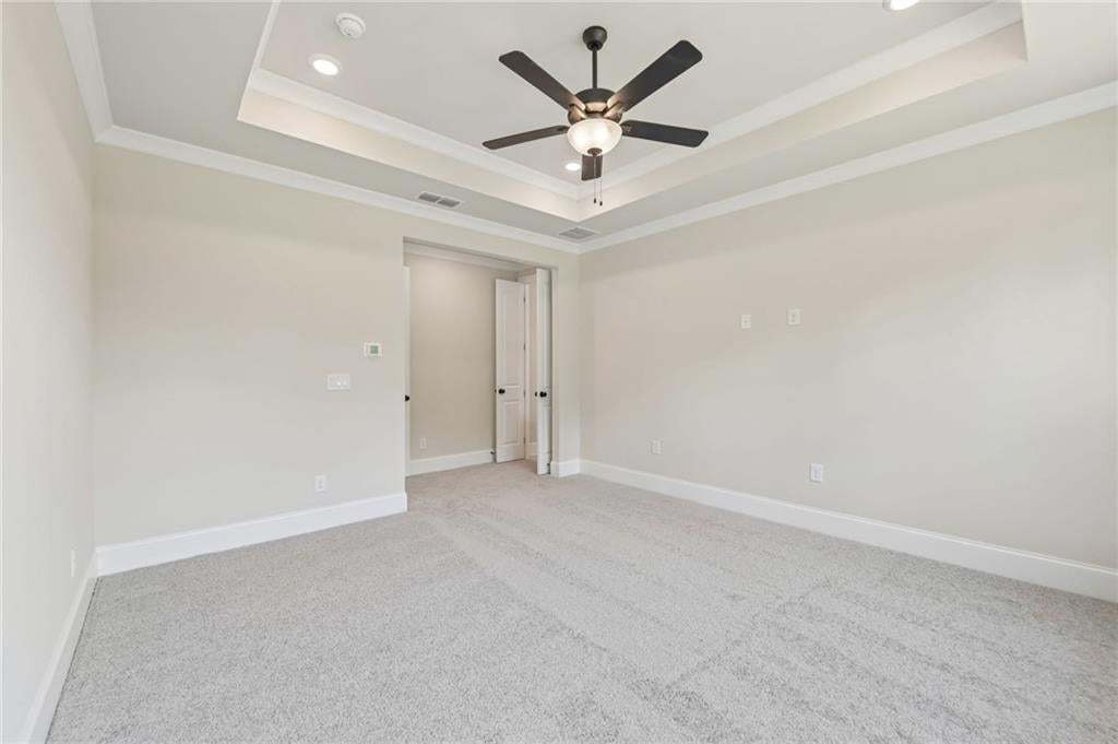 Tray ceiling with recessed lighting and crown molding