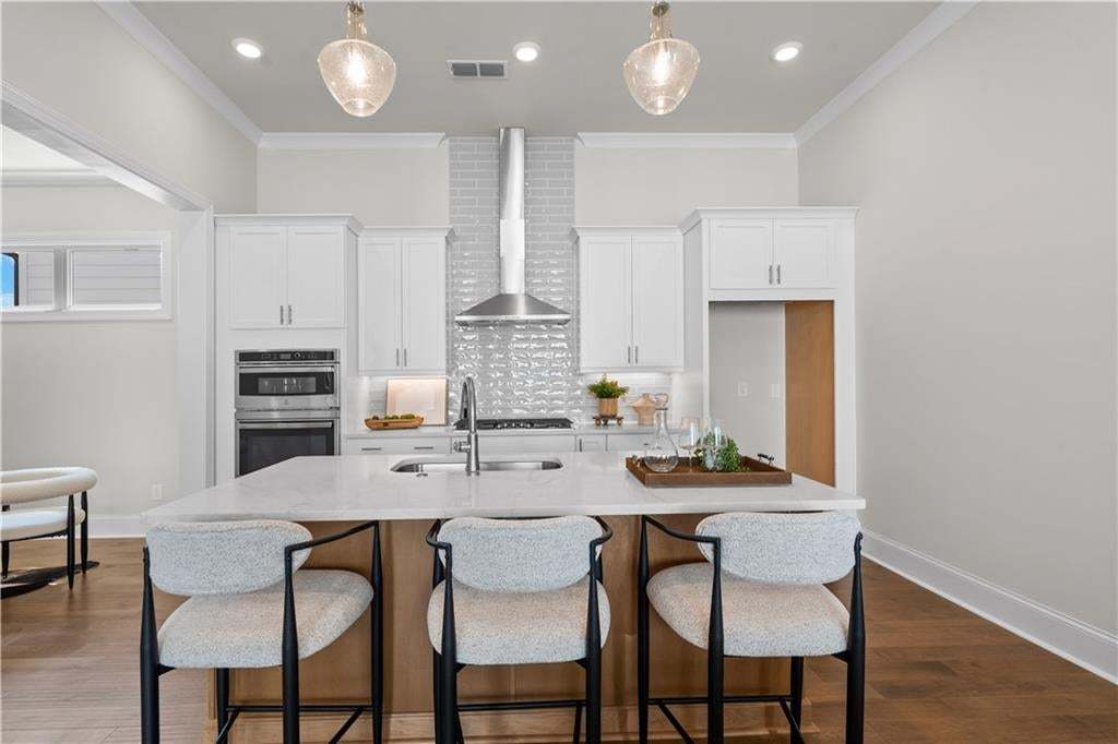 Open concept and plenty of space at the kitchen island for food prep, entertaining etc. Photo not of actual home but a similar TPG previously built home.