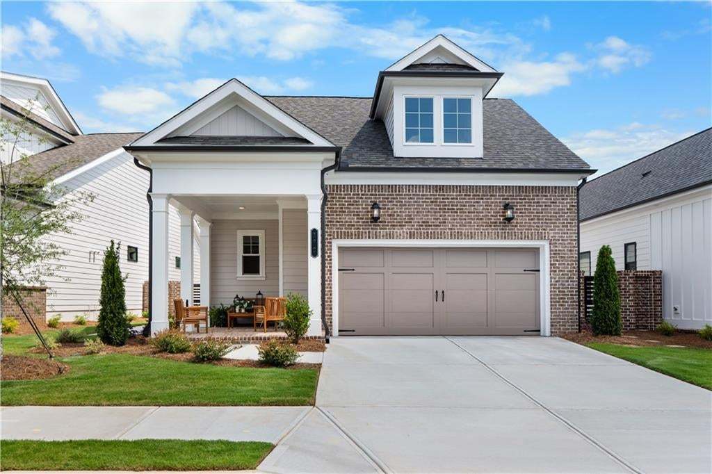 Love the front porch and when you walk along landscaped sidewalk, you will find the inviting front door to this super cute home. Photo not of actual home but a similar TPG previously built home.