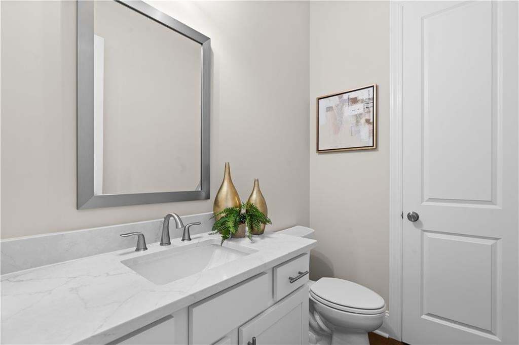 The powder room has a closet for extra storage. Photo not of actual home but a similar TPG previously built home.