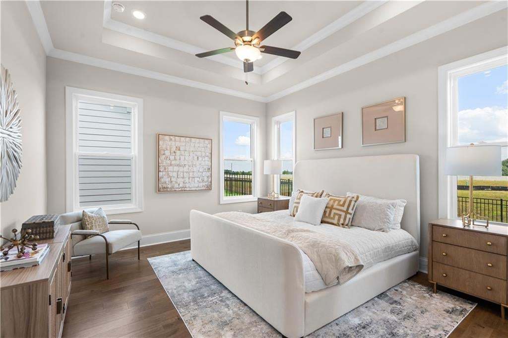 Primary bedroom with ample light.  Located on main floor. Photo not of actual home but a similar TPG previously built home.