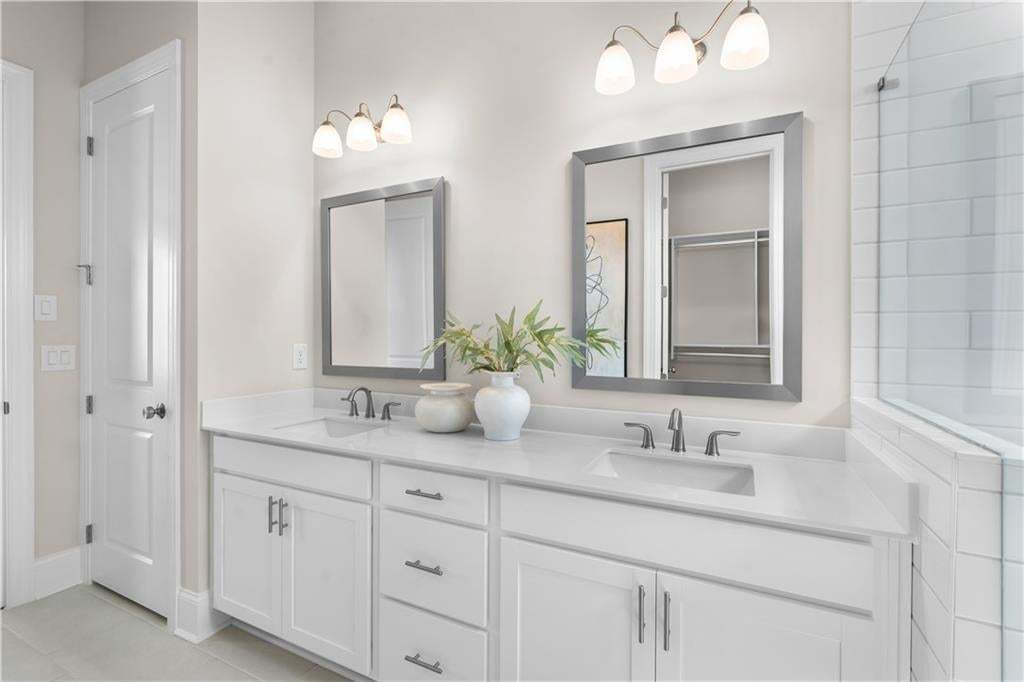 Dual sinks make getting ready easy.  Tons of storage as well. Photo not of actual home but a similar TPG previously built home.