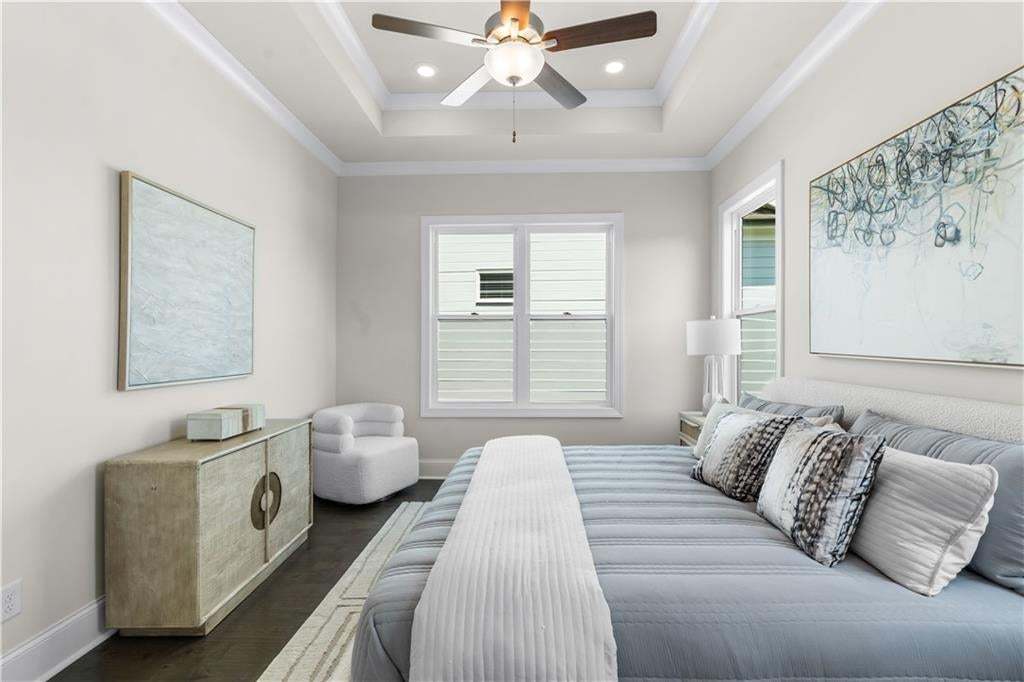 Primary bedroom has tons of natural light and is found on the main floor of this home. Photo not of actual home but a similar TPG previously built home.