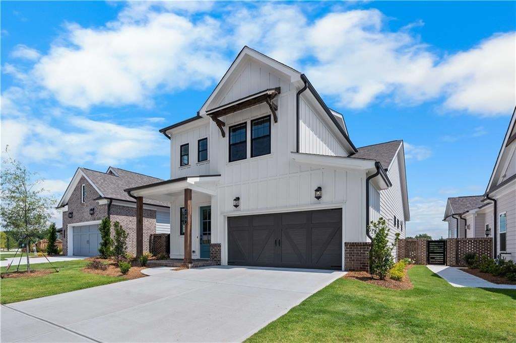 Modern farmhouse exterior featuring vertical white siding, decorative timber corbels, brick masonry base, and an attached multi-panel garage door