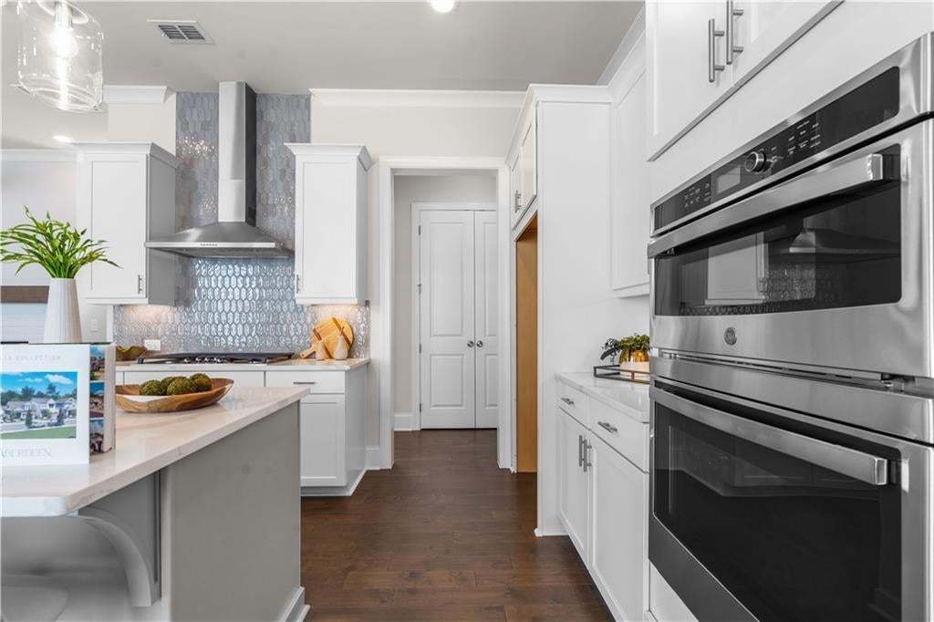 Two car garage on front of home, tankless water heaters are standard! Photo not of actual home but a similar TPG previously built home.