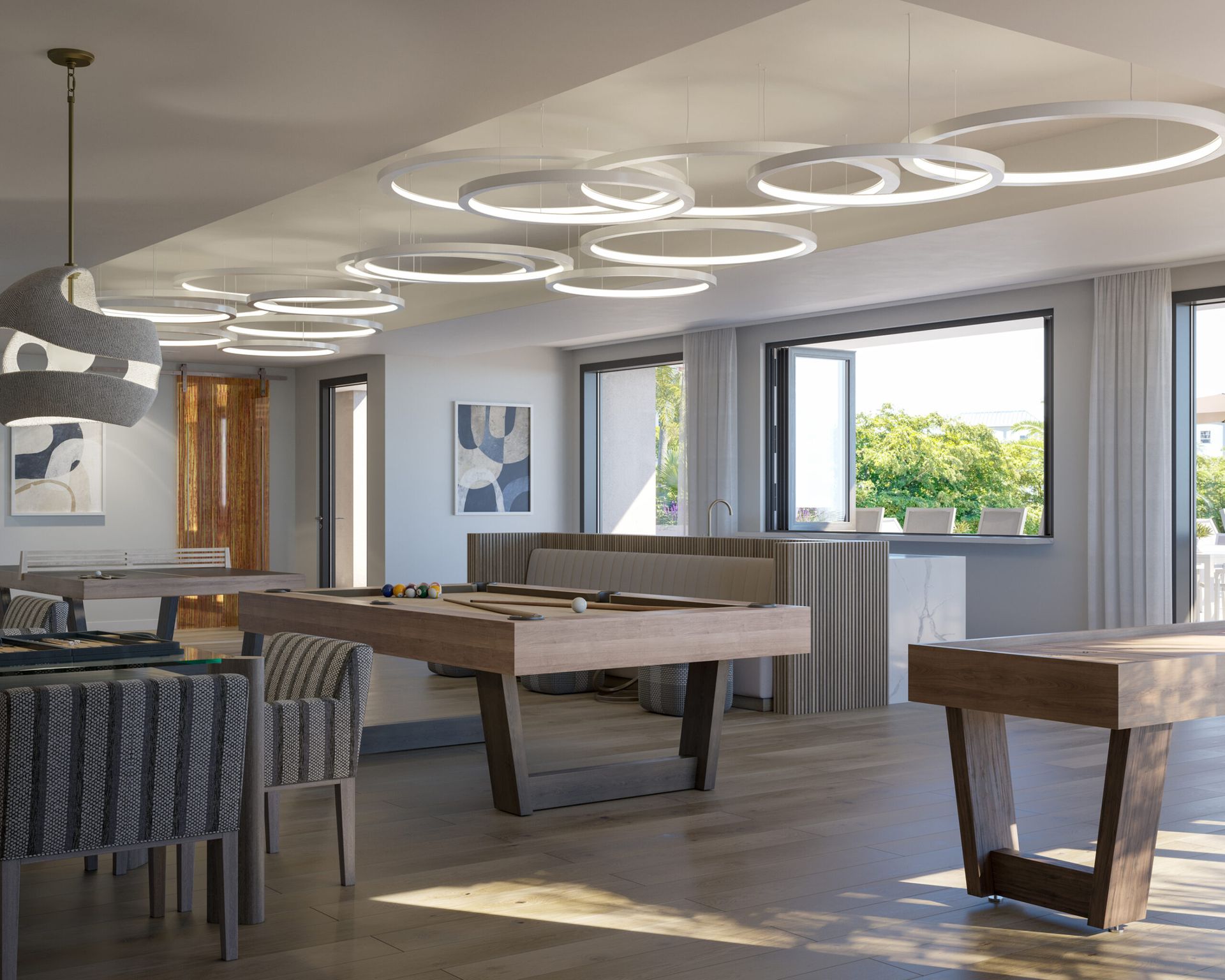 Game room with social seating, pool table, and indoor/outdoor bar.