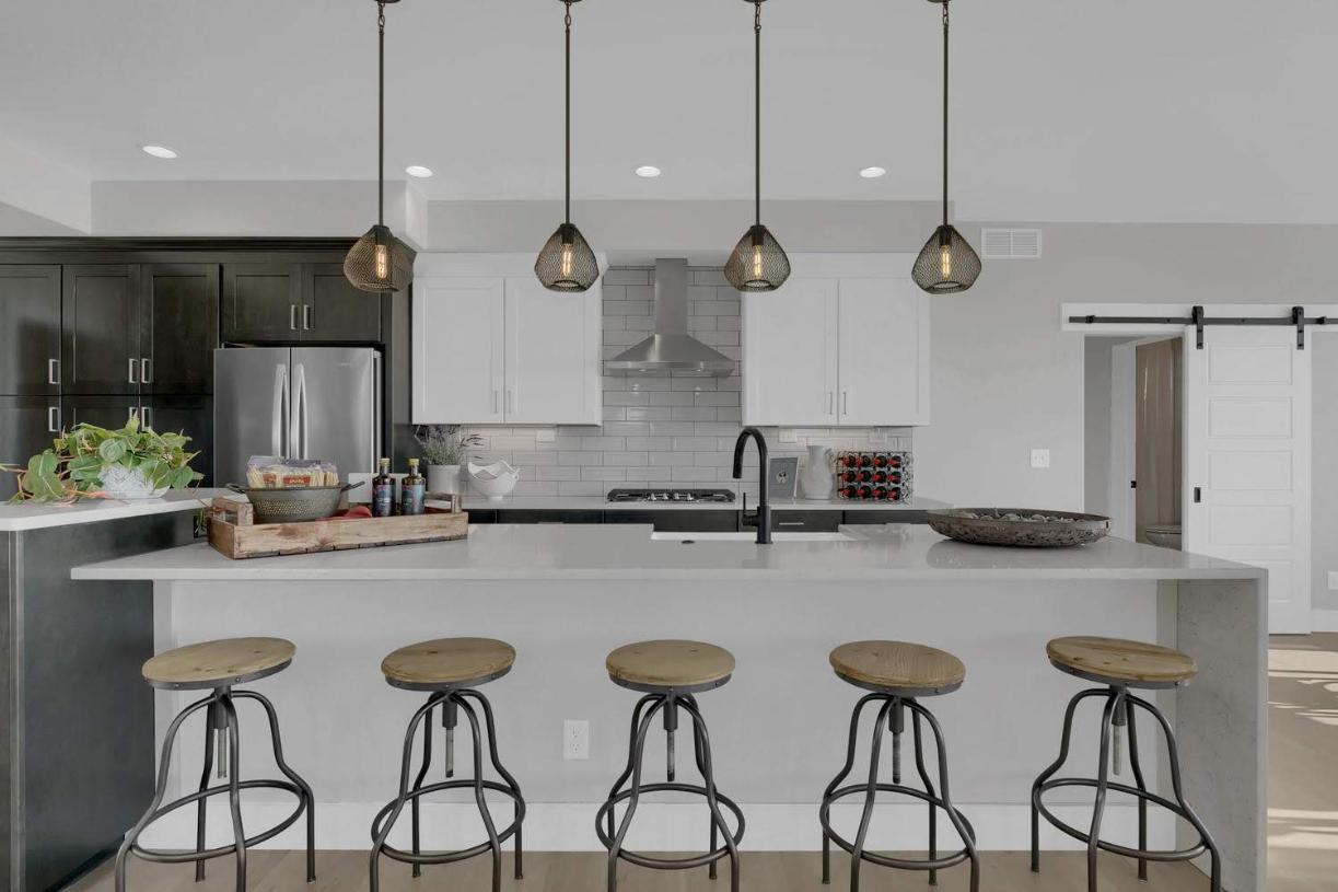 The family-sized kitchen features a large, centered island and stone countertops