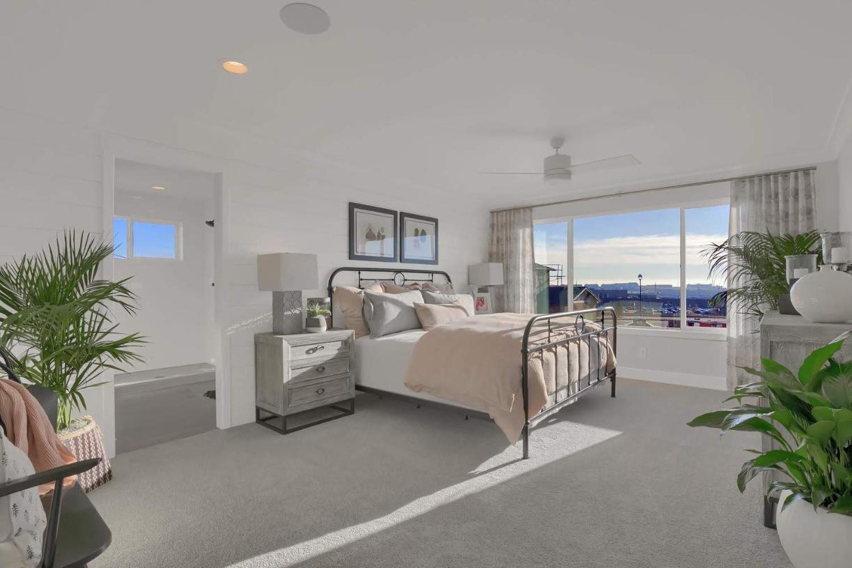 The primary bedroom suite affords space for larger furniture and a cozy sitting area