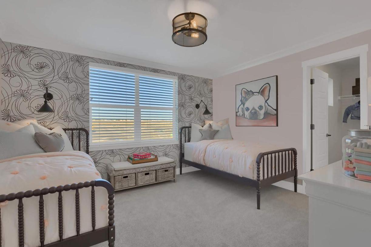 One of the secondary bedrooms with a walk-in closet