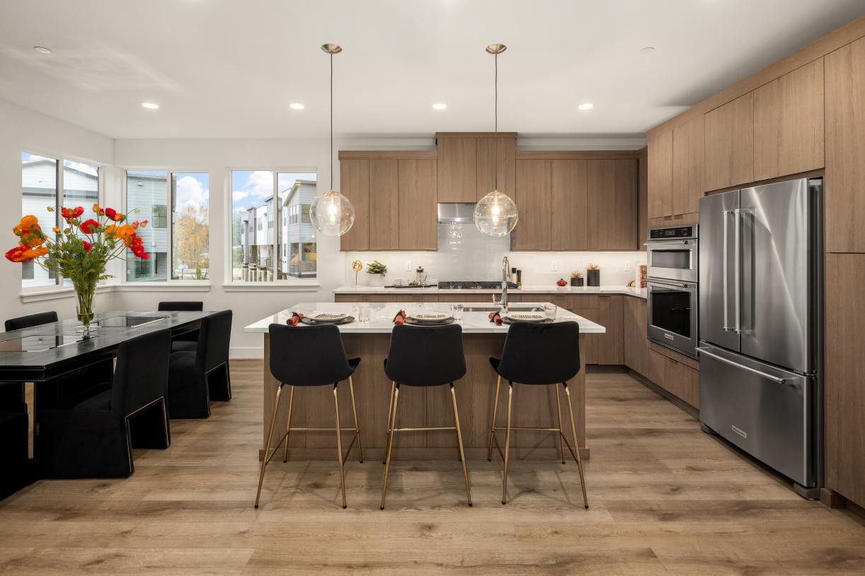 Kitchen features contemporary flat panel cabinetry in a warm wood tone