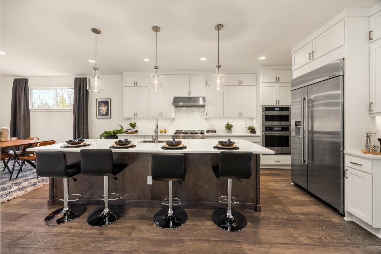 Well-designed kitchen with white shaker double-stacked cabinets