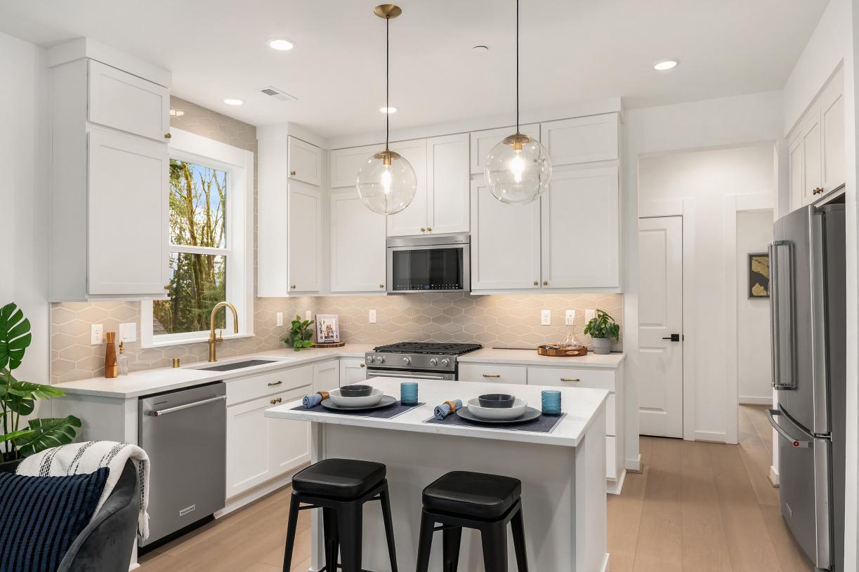 Kitchen offers double-stacked white shaker cabinets for additional storage