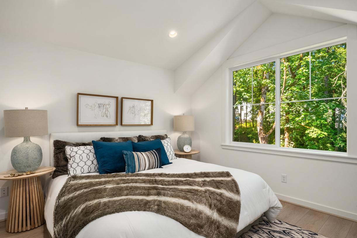 Primary bedroom offers a vaulted ceiling