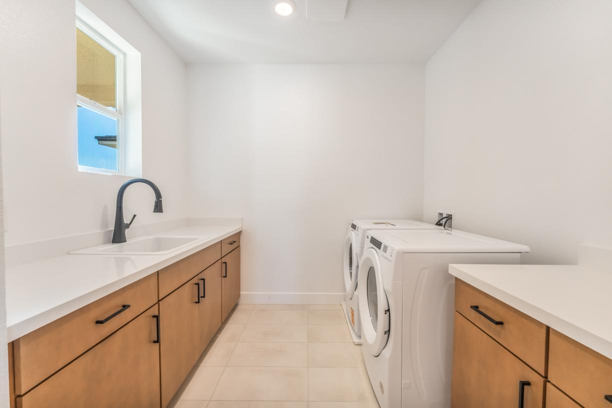Spacious laundry with cabinets and sink