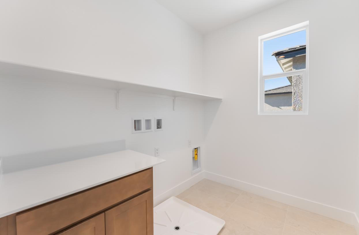 Spacious laundry with cabinets