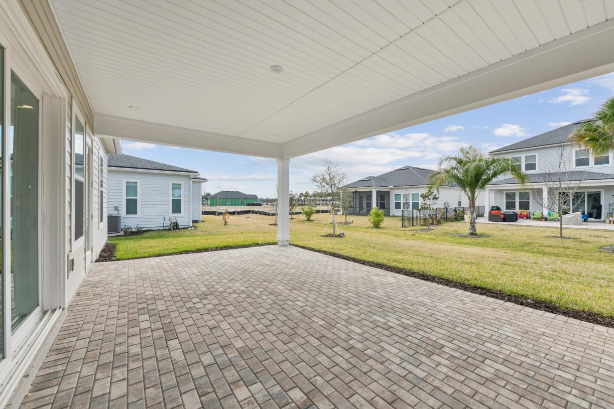 Extended covered lanai ideal for outdoor living, dining, and entertaining