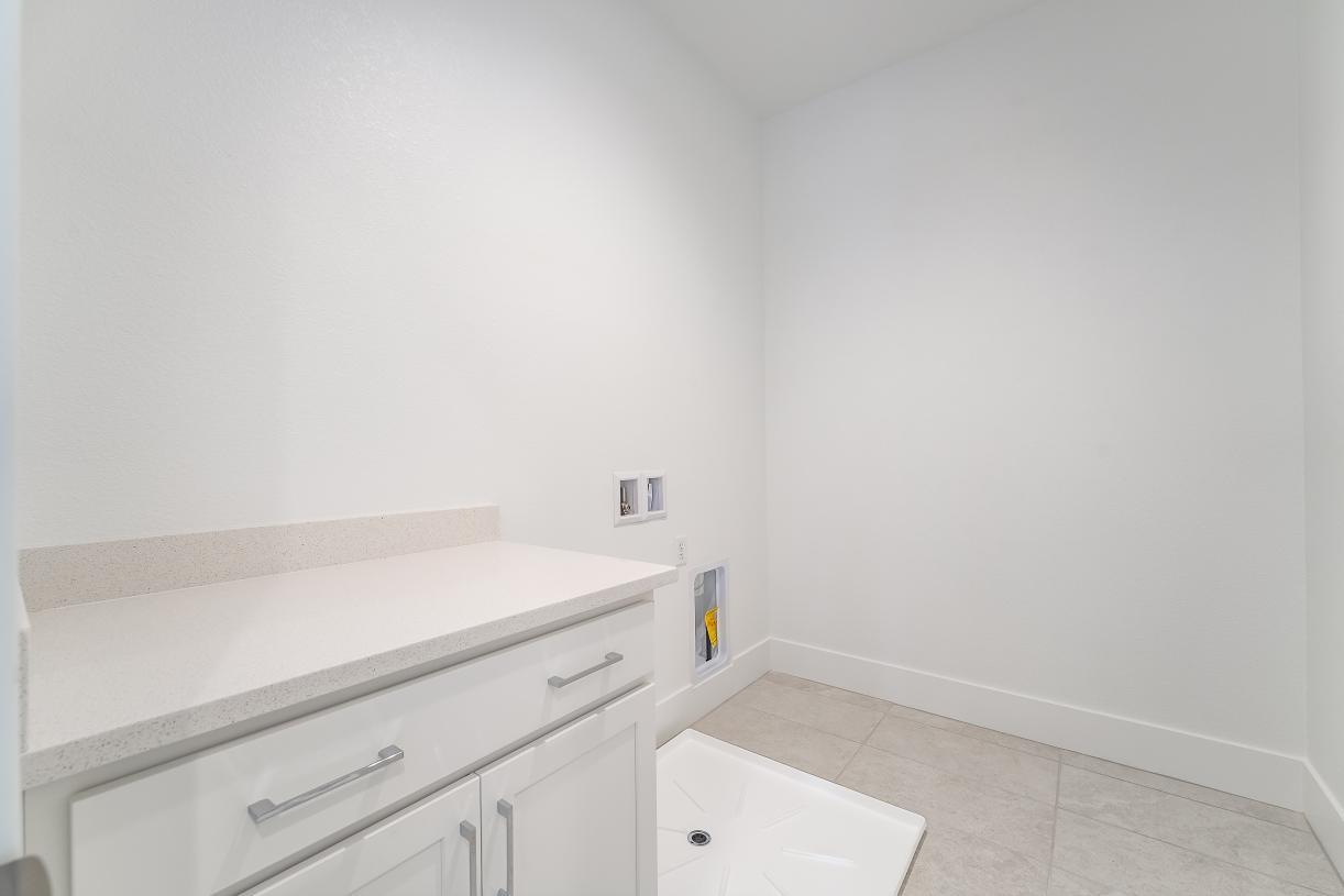 Spacious laundry with cabinets