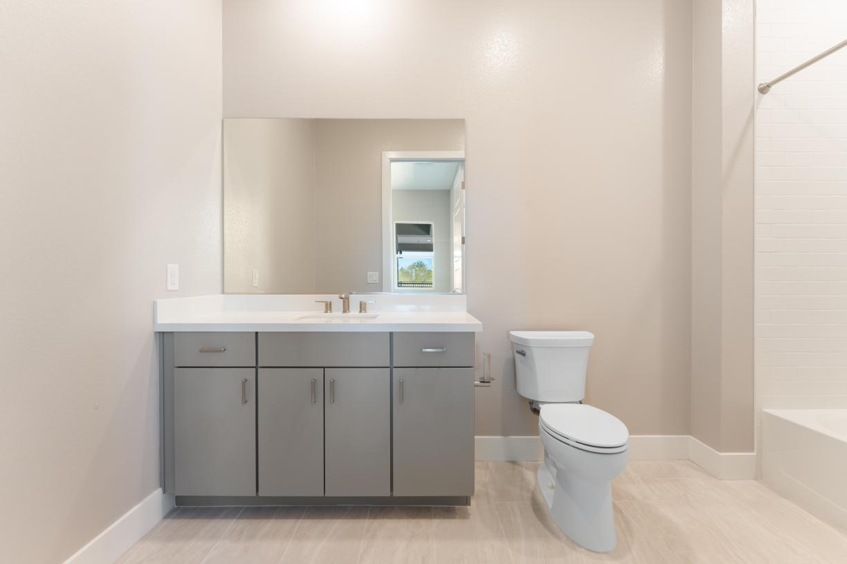 En-suite bath with large tile surround shower at secondary bedroom