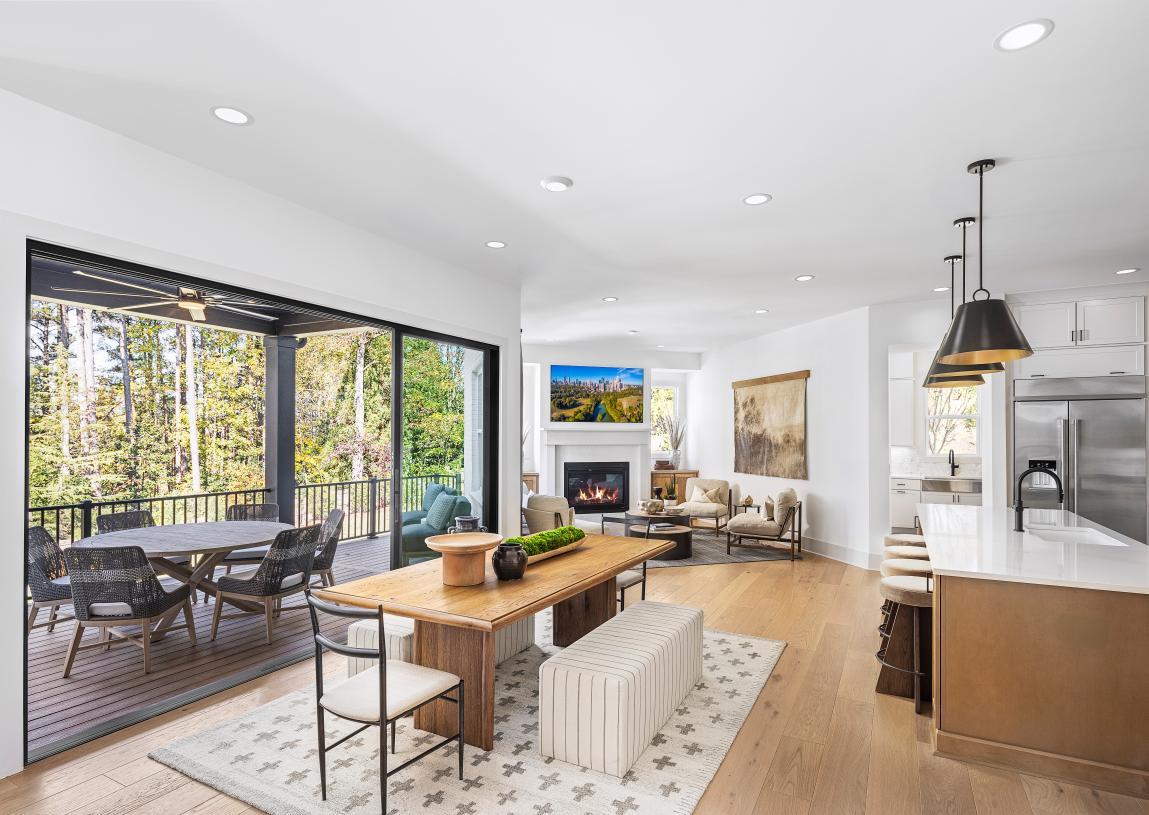 An inviting casual living space with a fireplace, adjacent to the kitchen