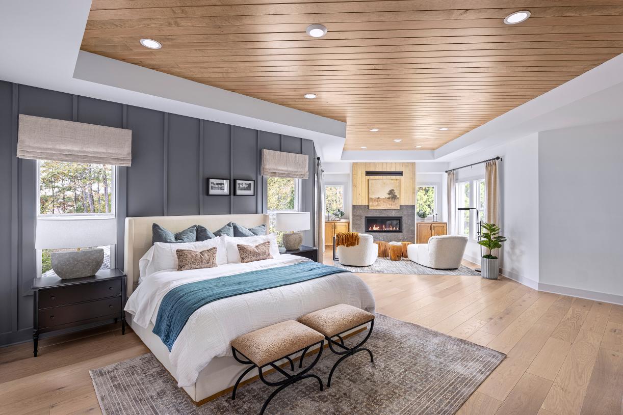 A luxurious primary suite featuring a cozy retreat and fireplace