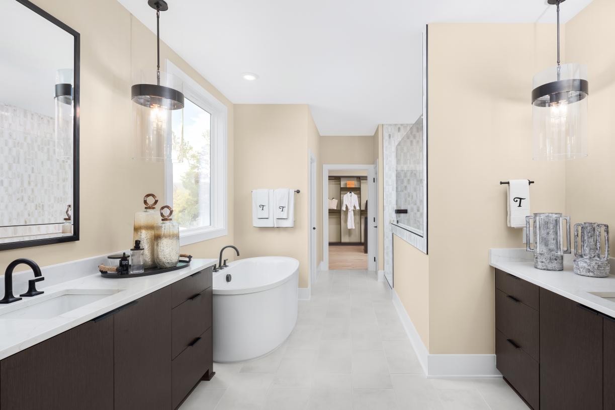 Primary bath featuring dual vanities and soaking tub