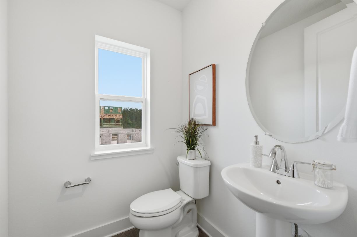 The powder room makes a stylish statement with thoughtfully selected details