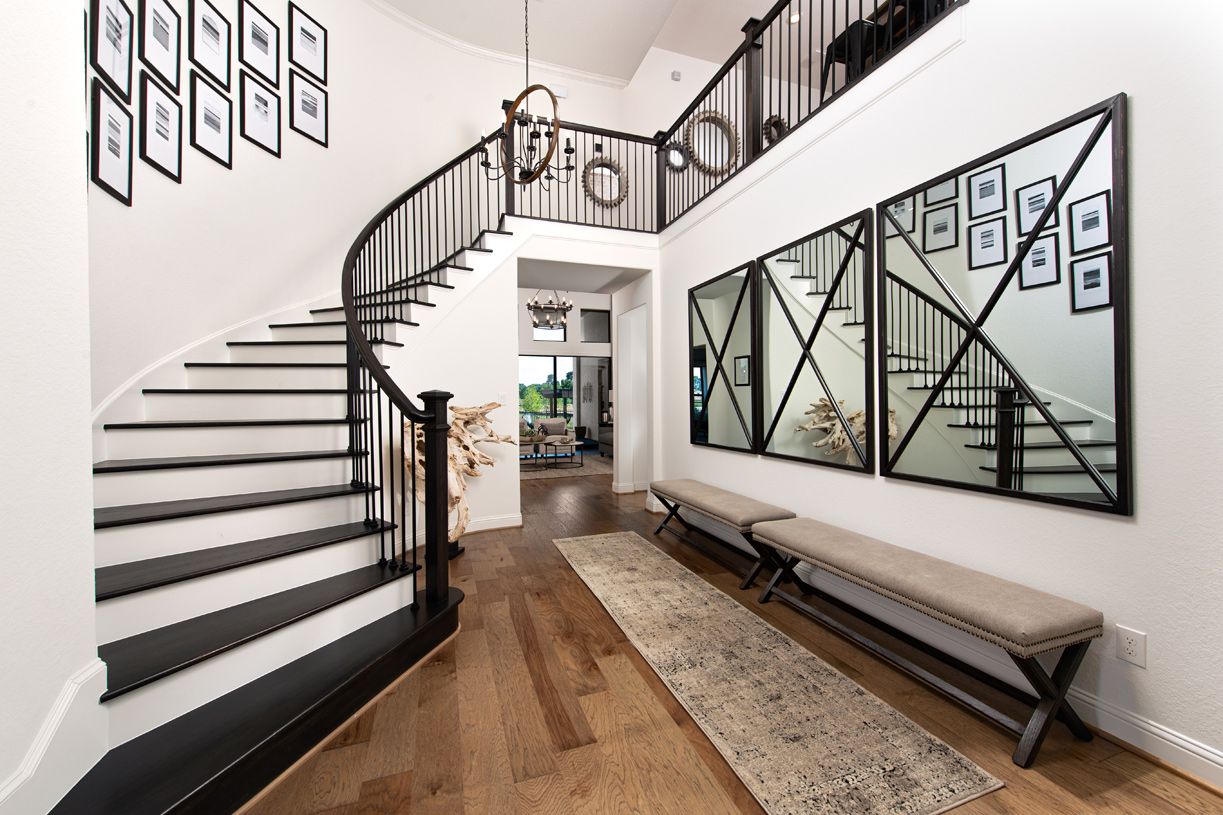 Two-story foyer with elegant curved staircase