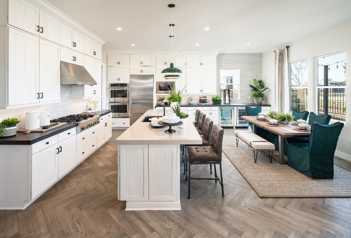 Kitchen with white cabinets, quartz countertops and stainless steel appliances