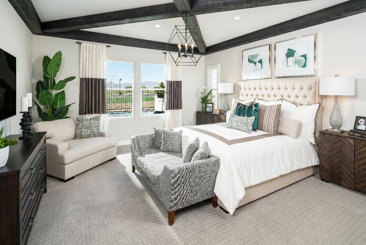 Primary bedroom suite with hand hewn beams