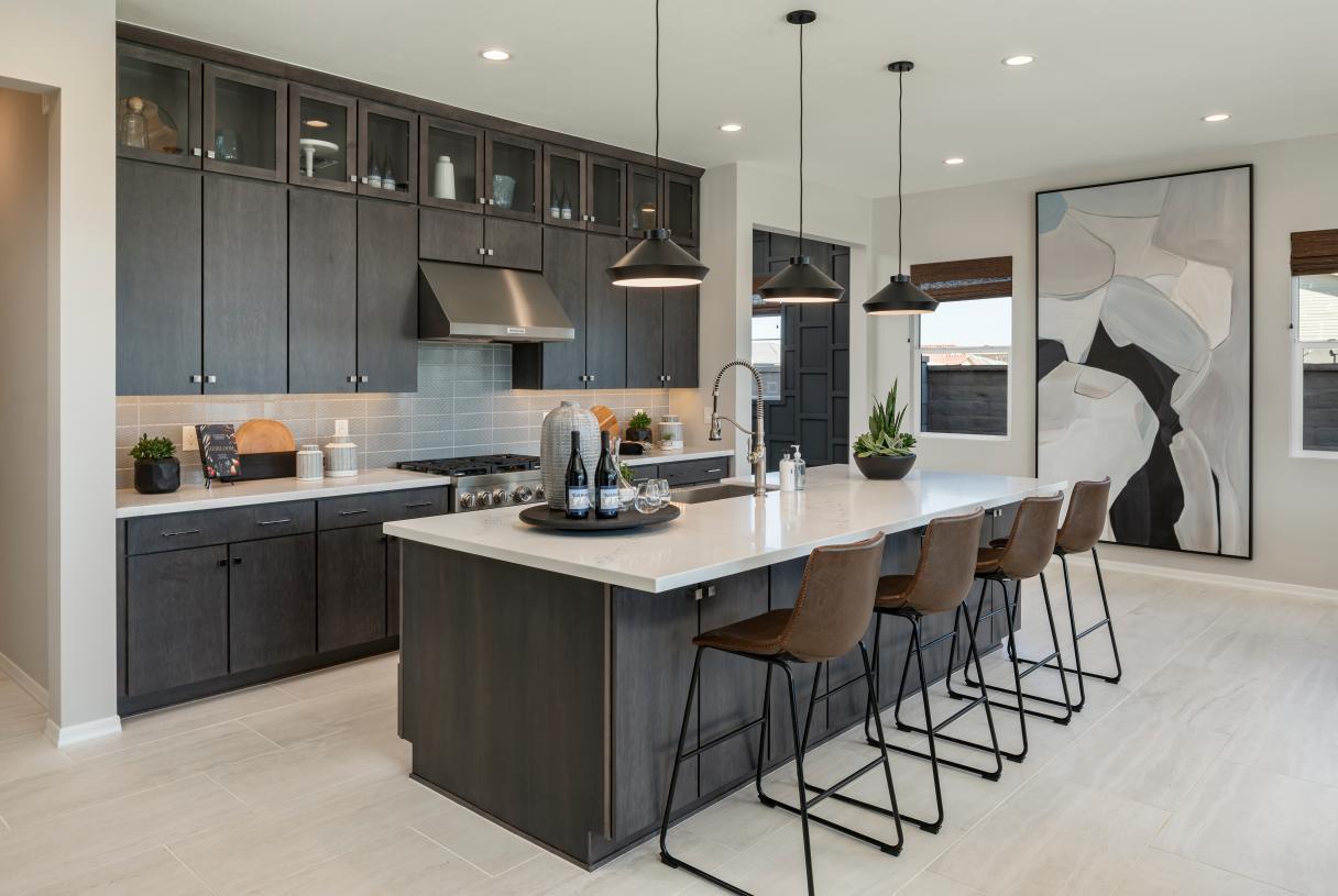 Well-designed kitchen with large center island, breakfast bar, and sizeable pantry