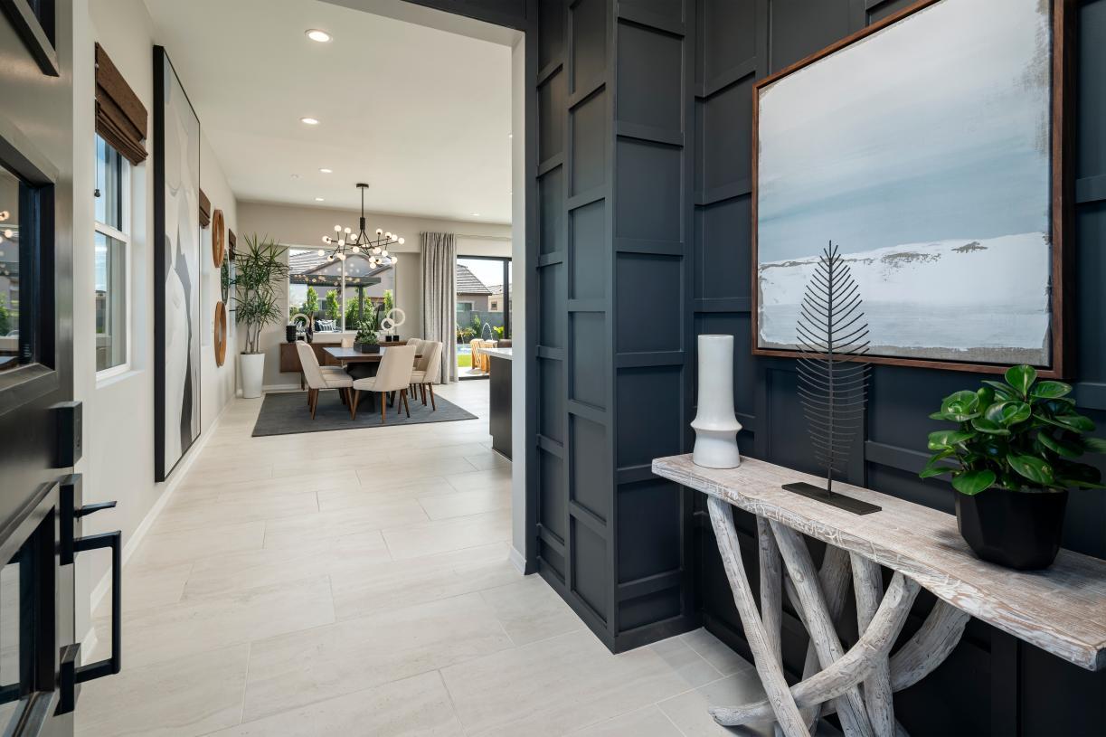 Welcoming foyer entry with views to the dining room, great room, and desirable covered patio beyond