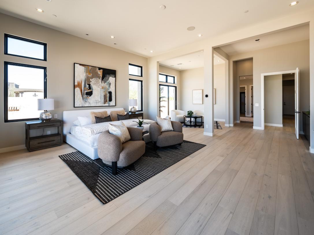 Gorgeous primary bedroom suite with neutral finishes and ample natural lighting