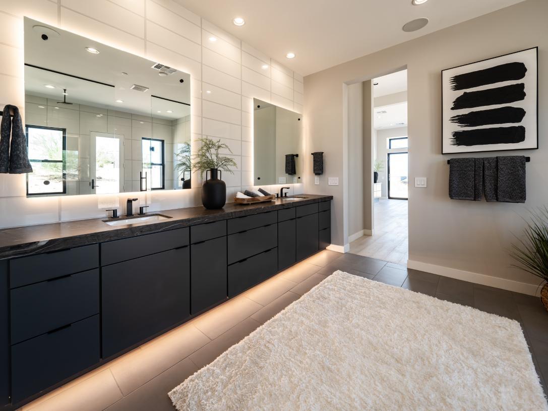 Primary bathroom with dual-sink vanity and striking modern finishes