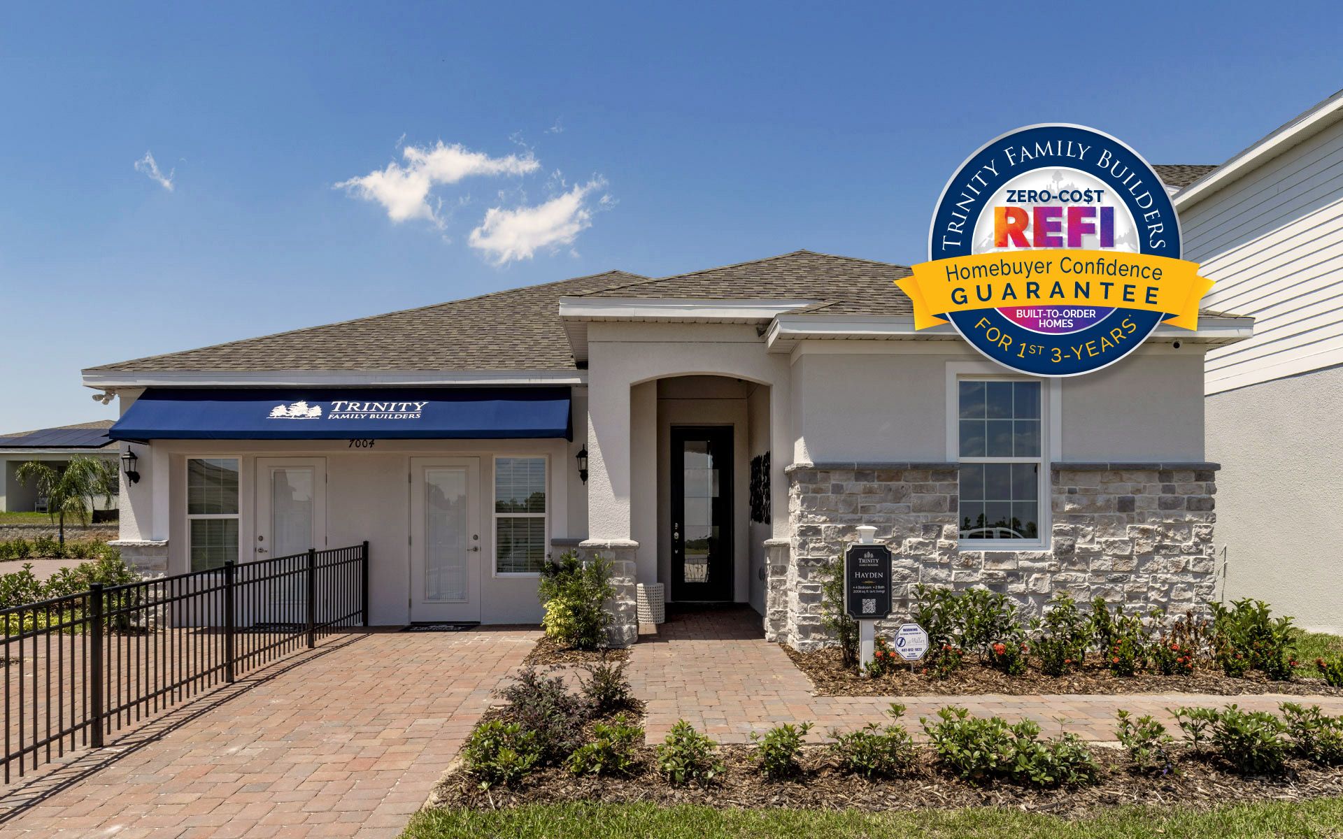 Hayden single-story home exterior with covered entry and lanai by Trinity Family Builders