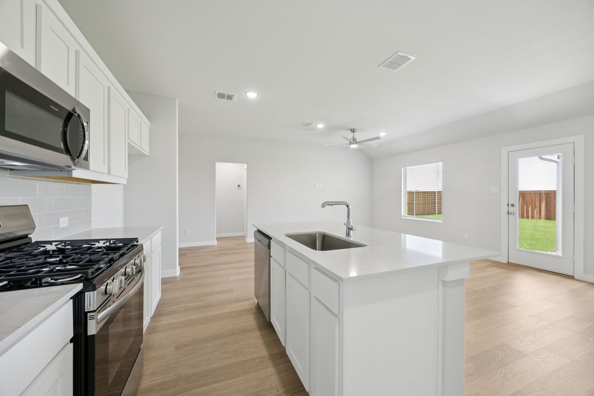 Kitchen in the Hadley home plan by Trophy Signature Homes – REPRESENTATIVE PHOTO