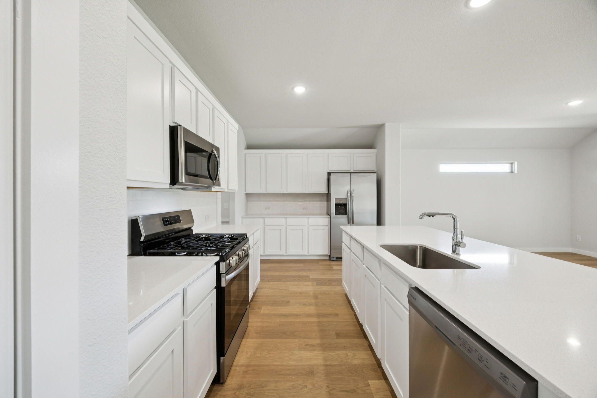 Kitchen in the Heisman home plan by Trophy Signature Homes – REPRESENTATIVE PHOTO