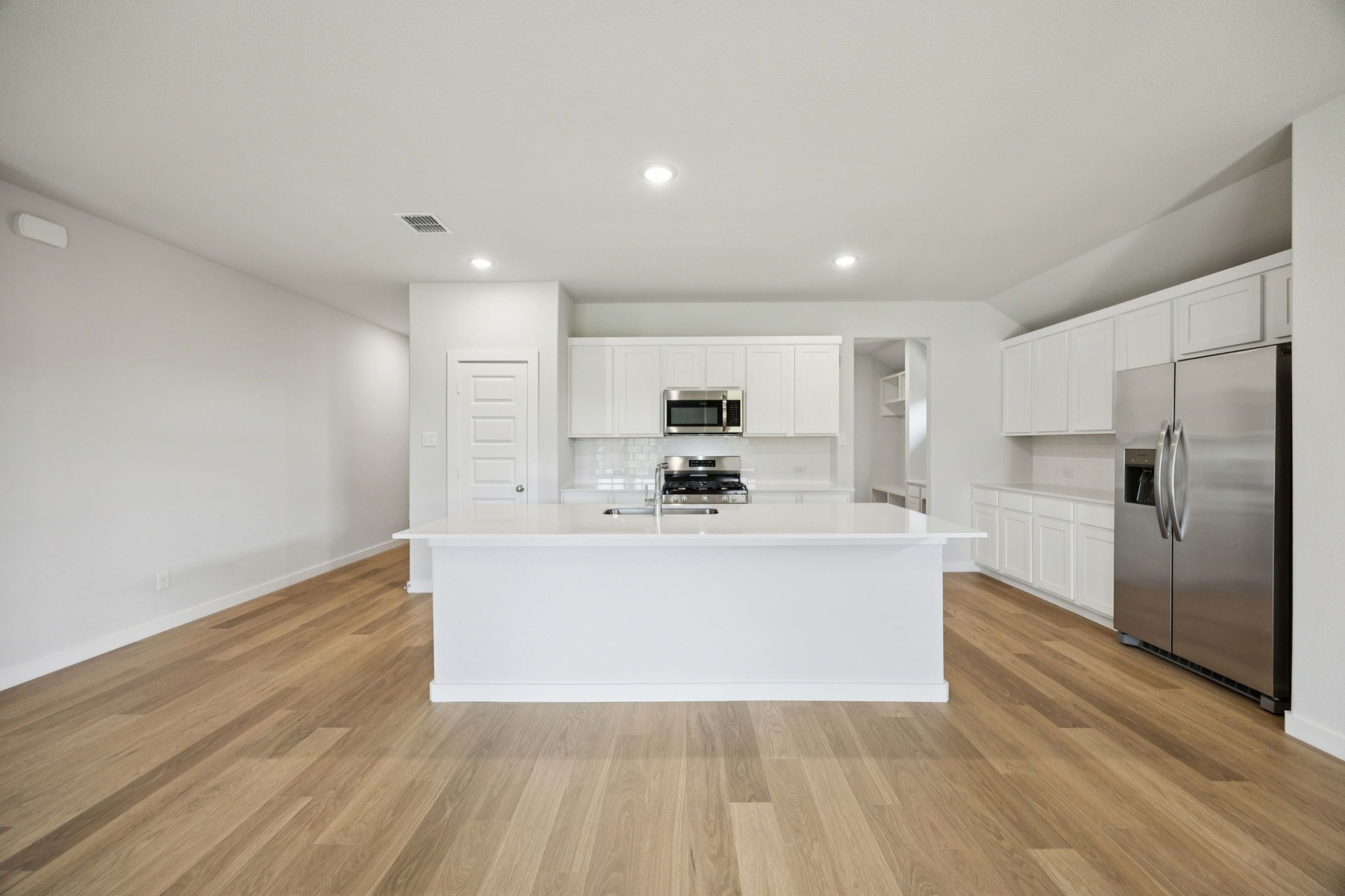 Kitchen in the Heisman home plan by Trophy Signature Homes – REPRESENTATIVE PHOTO