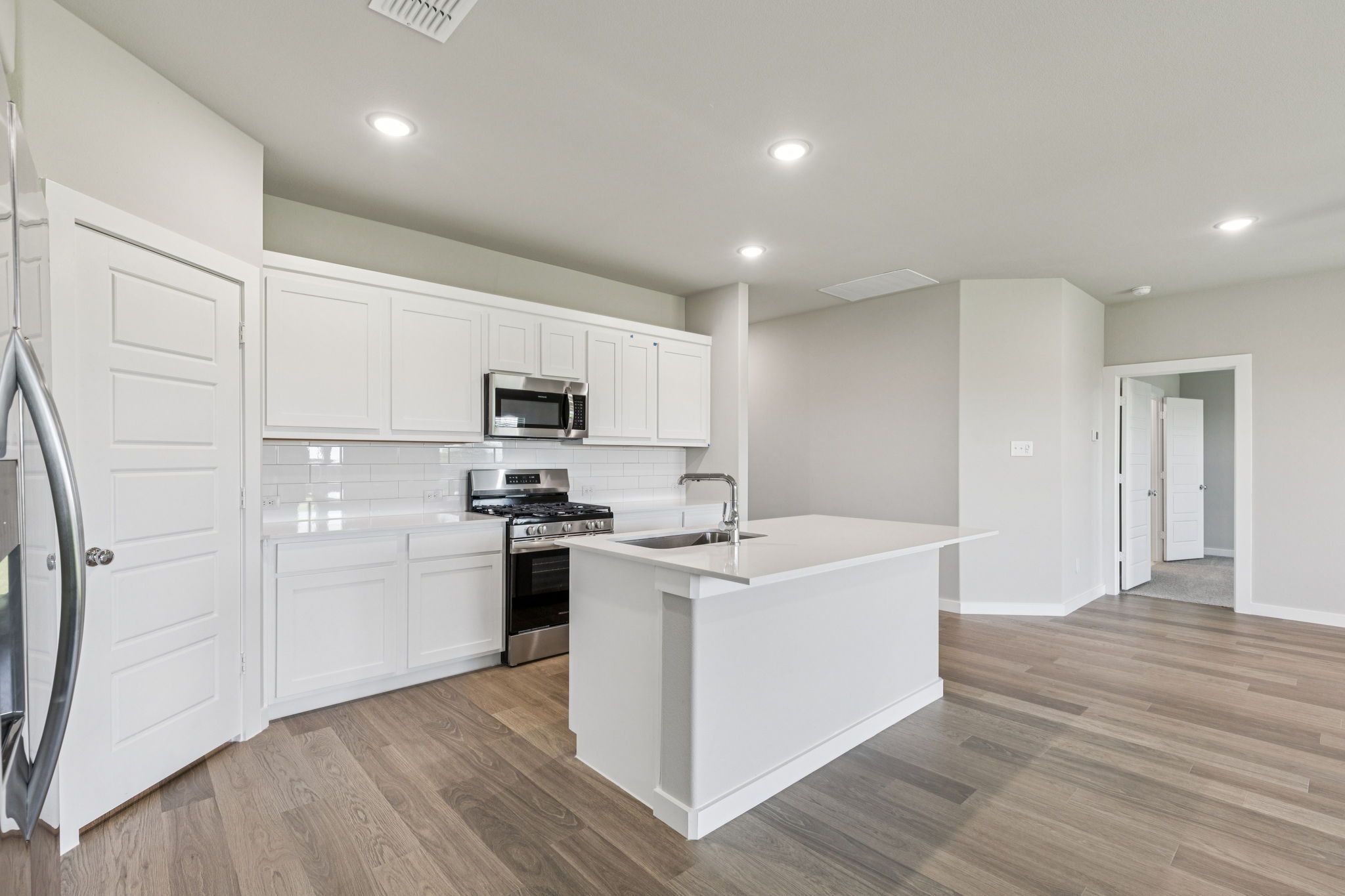 Kitchen in the Harper home plan by Trophy Signature Homes – REPRESENTATIVE PHOTO