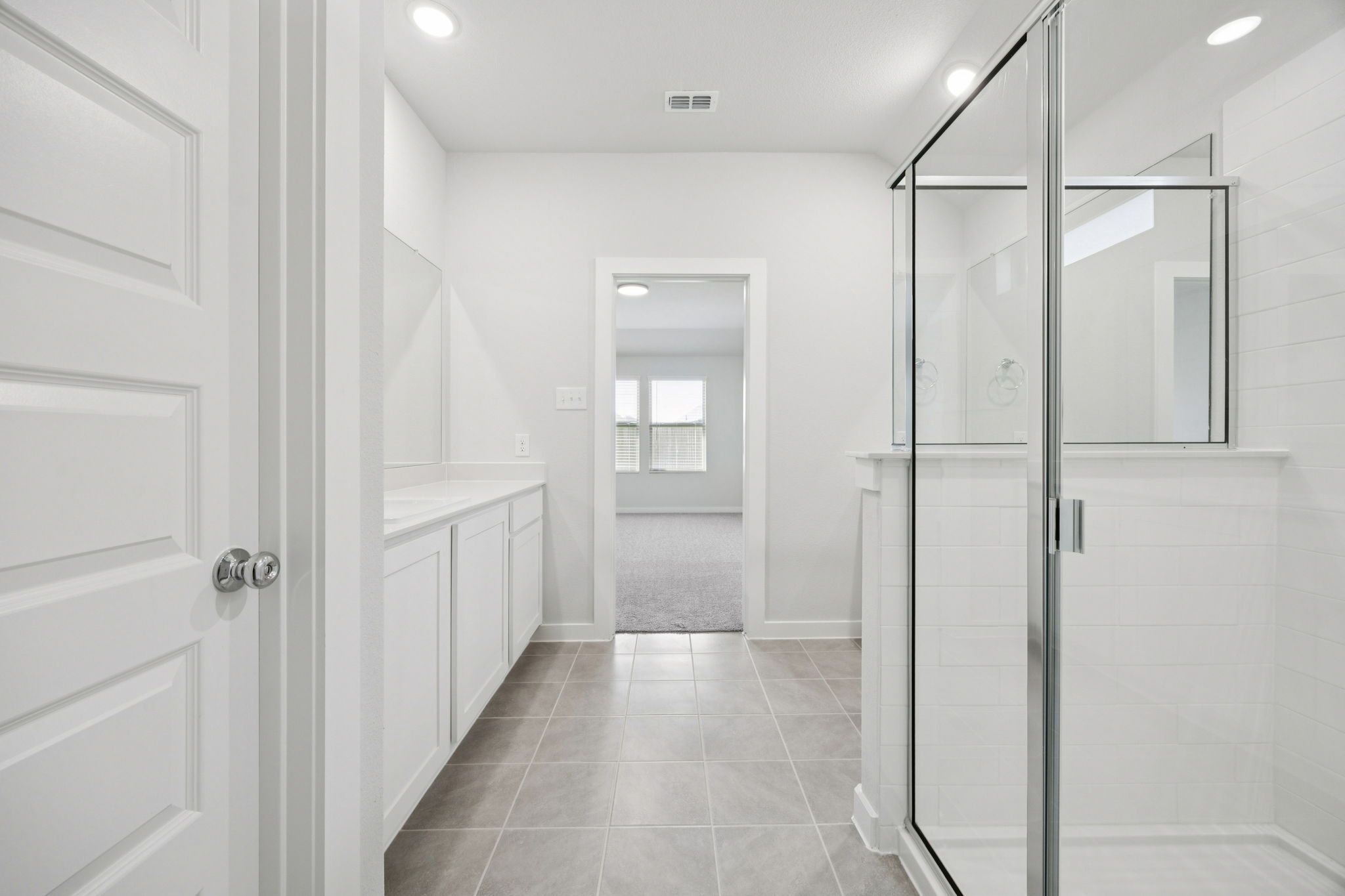 Primary Bathroom in the Heisman home plan by Trophy Signature Homes – REPRESENTATIVE PHOTO