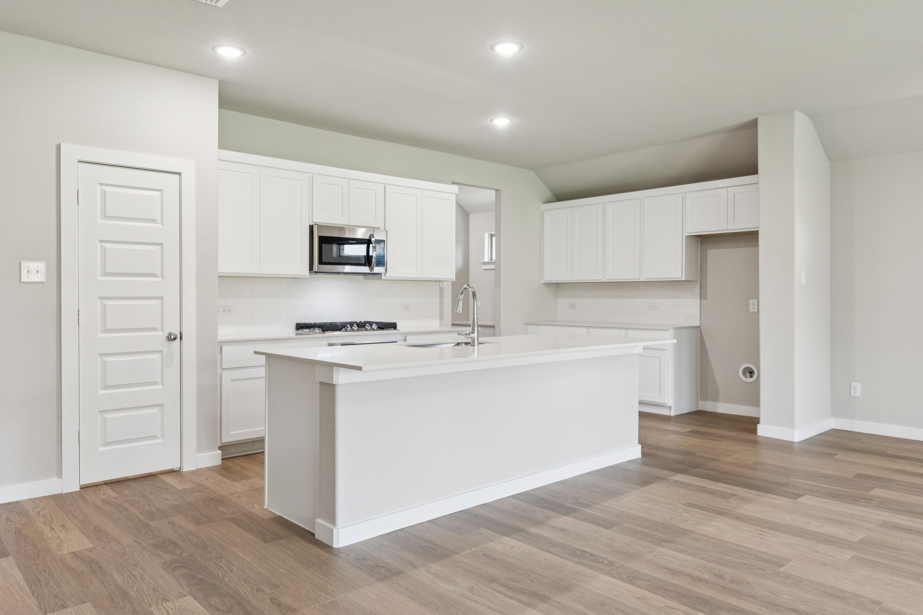 Kitchen in the Heisman home plan by Trophy Signature Homes – REPRESENTATIVE PHOTO