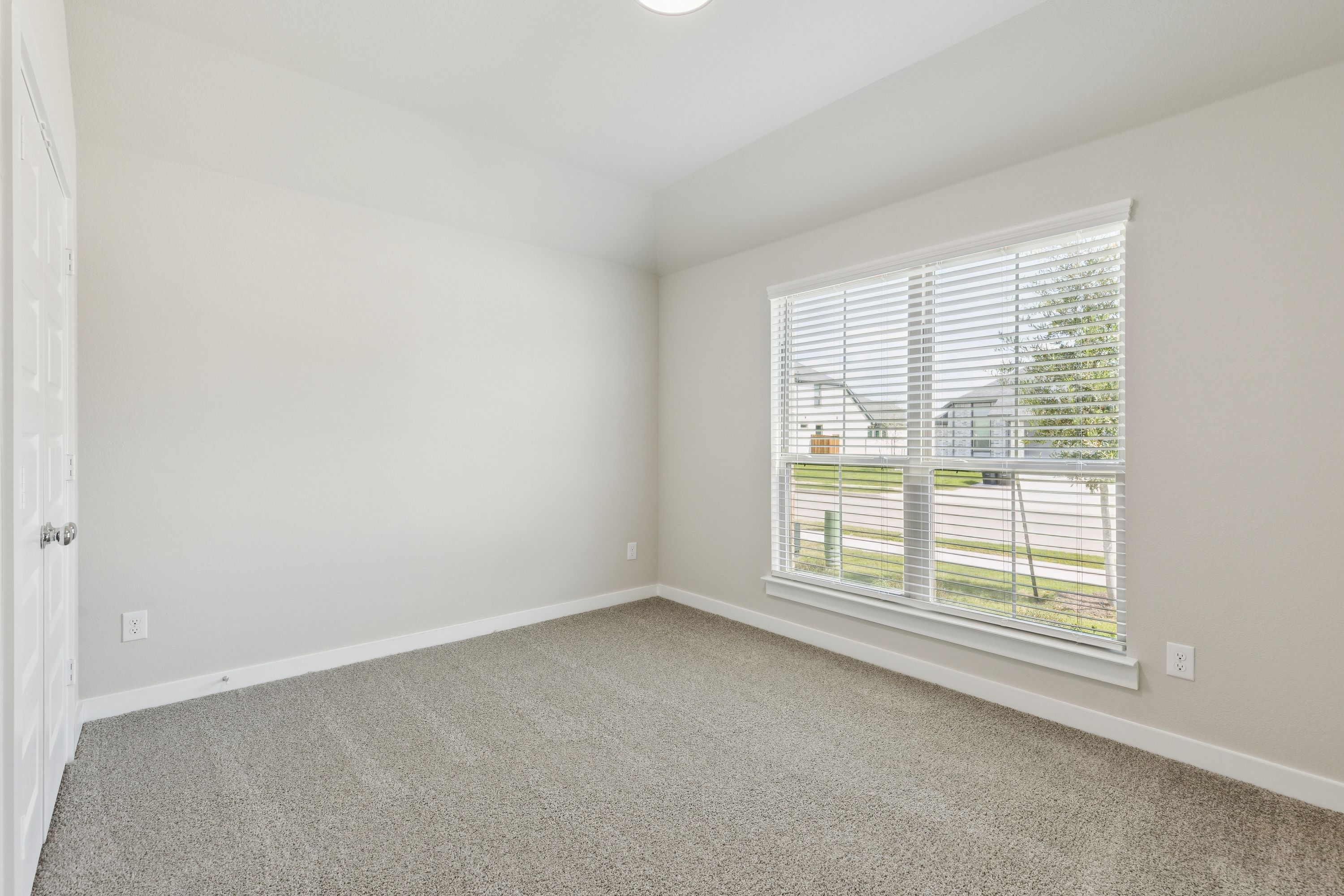Bedroom in the Heisman home plan by Trophy Signature Homes – REPRESENTATIVE PHOTO
