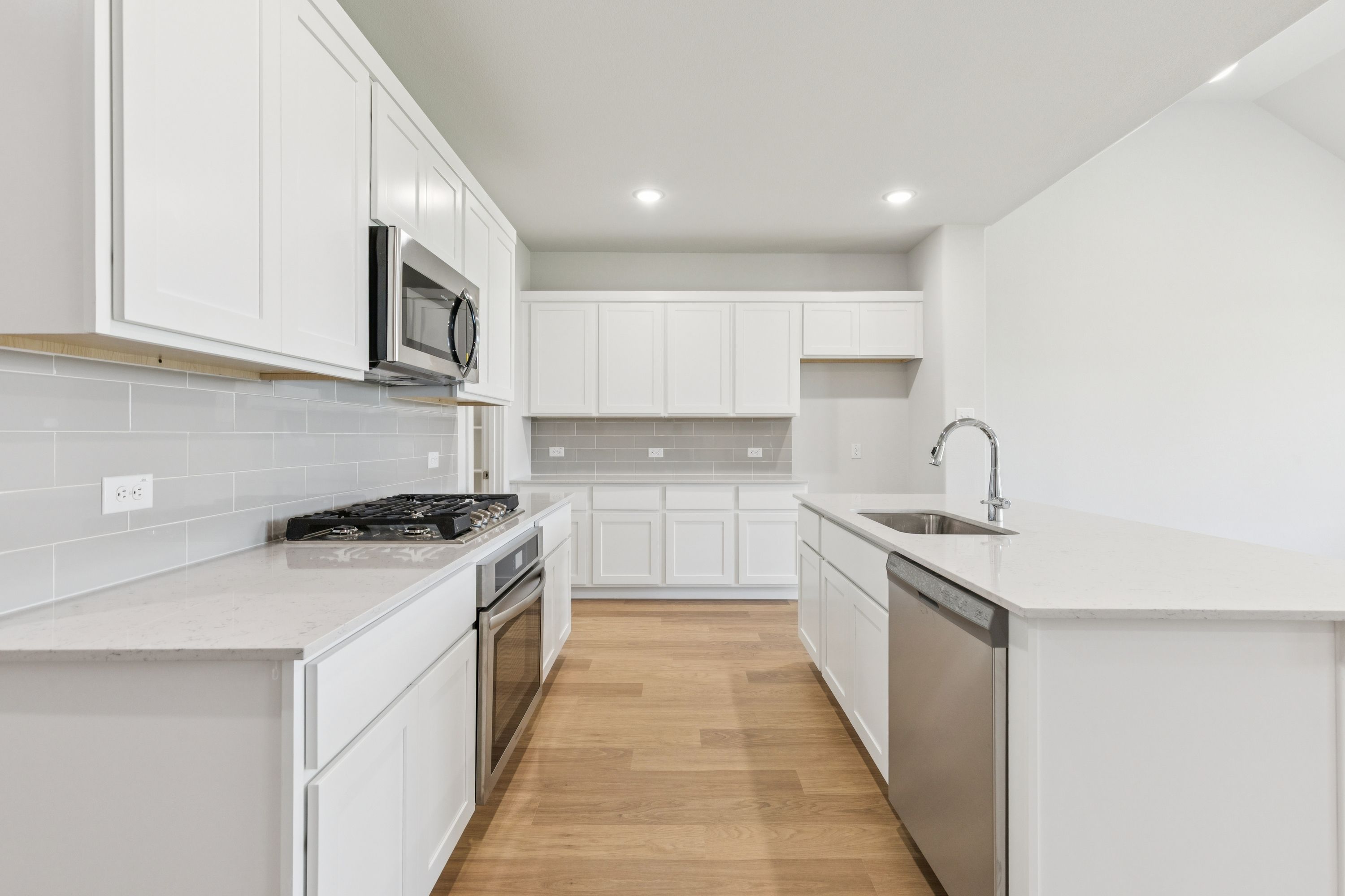 Kitchen in the Masters home plan by Trophy Signature Homes – REPRESENTATIVE PHOTO