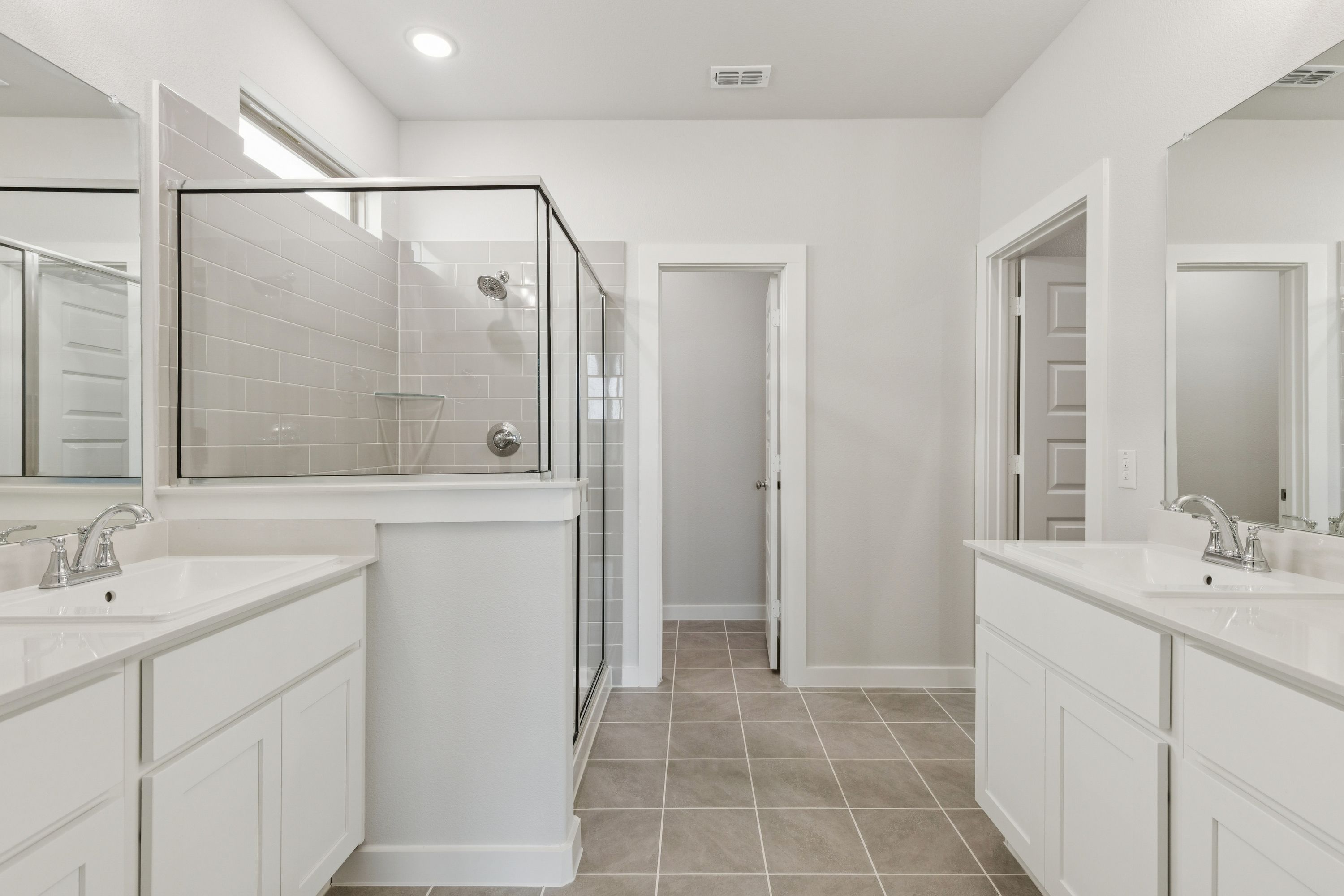 Primary Bathroom in the Masters home plan by Trophy Signature Homes – REPRESENTATIVE PHOTO