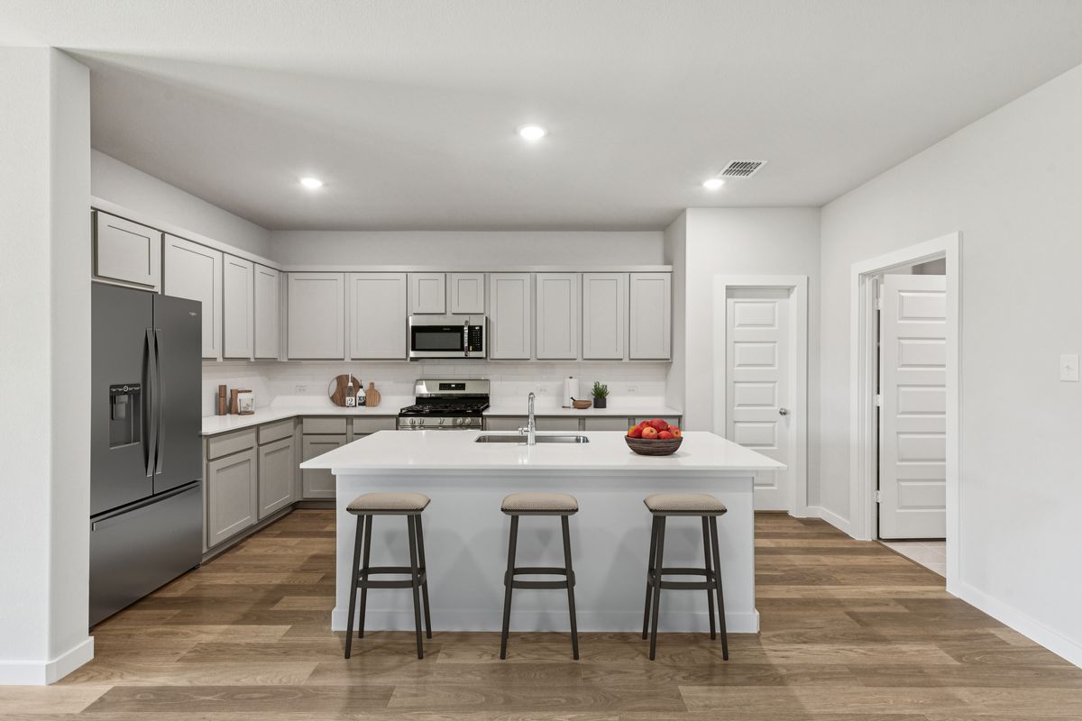 Kitchen in the Oscar home plan by Trophy Signature Homes – REPRESENTATIVE PHOTO