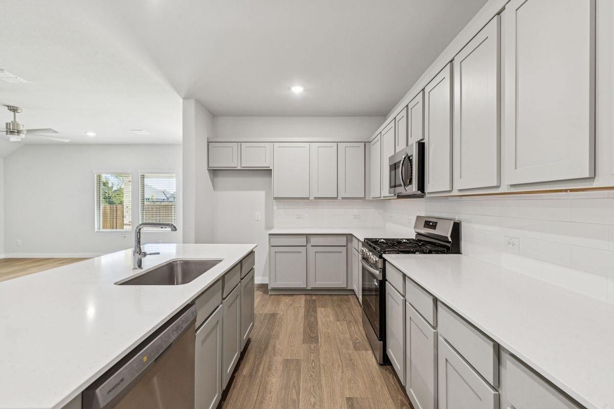 Kitchen in the Oscar home plan by Trophy Signature Homes – REPRESENTATIVE PHOTO