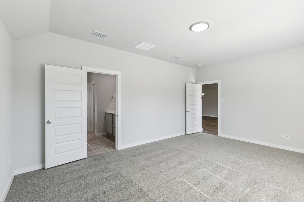 Primary Suite in the Oscar home plan by Trophy Signature Homes – REPRESENTATIVE PHOTO